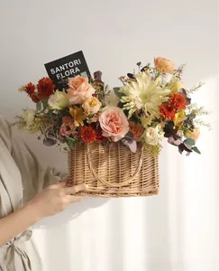 Detail view of handmade wicker basket with fresh pink roses and gift card