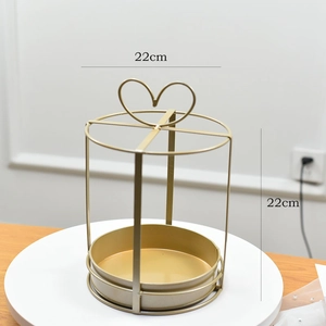Detail of a 22cm round gold metal flower stand with a heart-shaped handle for cakes