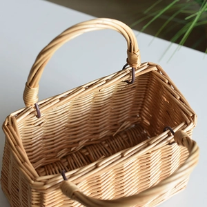 Close-up of a handmade rectangular wicker basket with double handles and natural texture