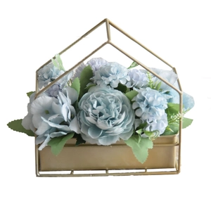 Blue faux peony flower arrangement in a minimalist gold iron house frame stand