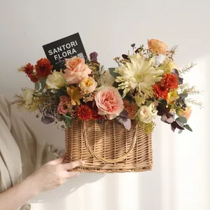 Handwoven flower basket with fresh roses and carnations in a pastoral style