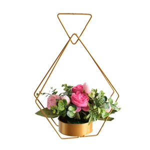Golden heart-shaped geometric metal flower basket with pink artificial floral design