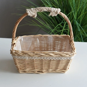 Handmade wicker picnic basket with lace trim and plastic liner for flower arrangement
