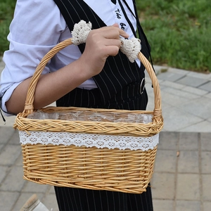 Handmade wicker picnic basket with white lace trim and curved handle for flower storage