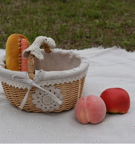 Detail of hand-woven wicker picnic basket featuring elegant lace lining and flower decor