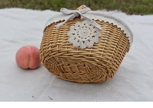 Close-up of handmade wicker basket with grey fabric lining and white lace trim detail