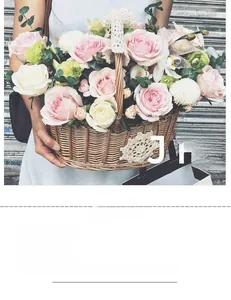 Detail of hand-woven oval willow basket with white lace trim and pink roses