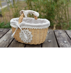Detail of hand-woven wicker basket with lace lining and crochet flower on wooden bench
