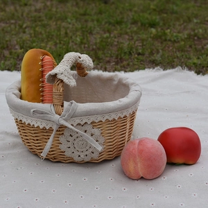 Handmade wicker picnic basket with linen lining and lace trim for outdoor gathering