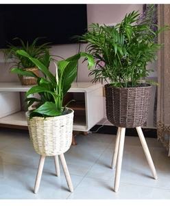 Detail of woven plant stand with natural wood legs for modern home interior decor