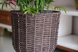 Close-up detail of dark brown woven texture on handmade plant basket for home decor