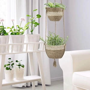 Two-tier woven jute hanging planter with white fiber accents and decorative tassels