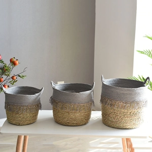 Three-piece set of woven seagrass storage baskets with grey fringe and double handles