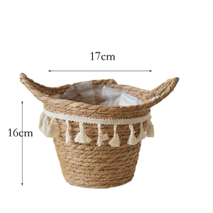 Detail showing the waterproof plastic lining and tassels on the 17cm woven plant basket