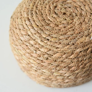 Macro shot of handcrafted spiral woven texture on natural seagrass plant basket