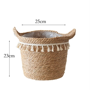 Detail of woven rattan plant basket with white tassels and waterproof plastic lining