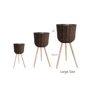 Three-piece set of woven wicker plant stands with wooden tripod legs in various sizes