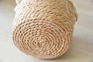 Detailed close-up of woven rattan flower basket showing natural fiber spiral base