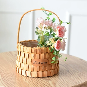 Handcrafted cylindrical wood woven basket with handle and decorative flower tag