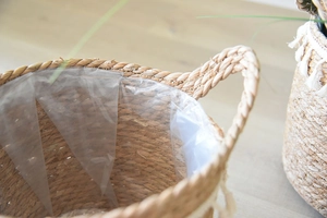 Close-up of the waterproof plastic liner inside the handwoven seagrass flower basket