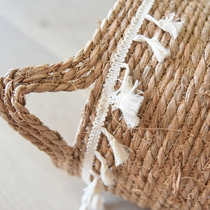 Handwoven Nordic seagrass planter basket with white tassels for indoor plants