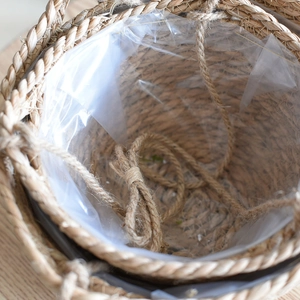 Detail of hanging seagrass planters showing waterproof PE liner and rustic jute rope handles