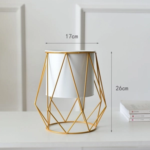 Detail view of modern white cylinder planter with gold geometric metal frame, 26cm height