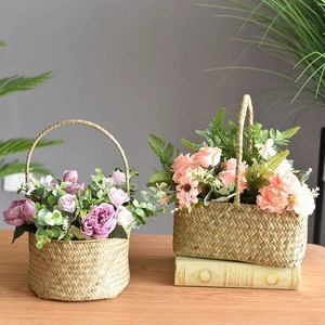 Handwoven seagrass flower baskets with vibrant artificial roses and daisies for decor