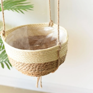 Detail showing natural seagrass hanging planter with woven texture and waterproof liner