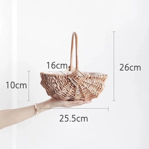 Handheld view of a brown woven flower basket with dimensions 25.5cm width and 26cm height