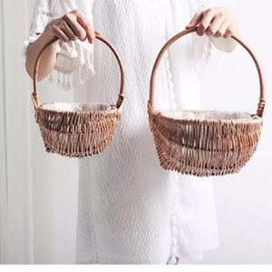 Set of two handmade woven flower baskets with handles in natural brown wicker