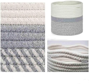 Close-up detail of two-tone woven cotton rope storage basket with built-in handles