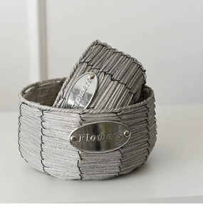 Close-up of woven flower pot texture with a decorative silver metal Flowers plaque