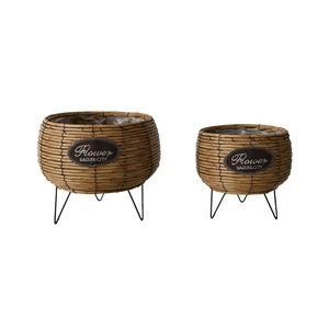 Set of two Nordic woven rattan flower pots with black metal legs and plastic lining