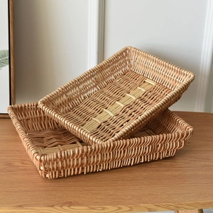 Pair of rectangular hand-woven rattan storage baskets on a natural wooden tabletop
