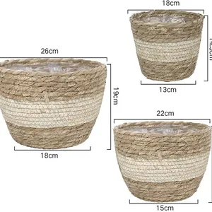 Three sizes of natural seagrass woven plant pots with striped design and plastic liners