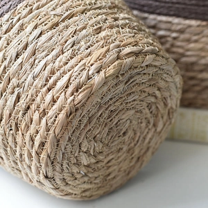 Handwoven natural seagrass planter basket with detailed spiral weave texture