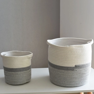 Detail of grey and white cotton rope woven storage baskets with invisible handles