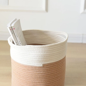 Close-up of cotton rope storage basket with dual handles in beige and brown tones