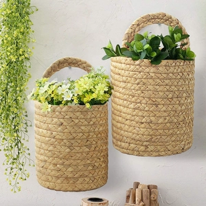 Handwoven seagrass wall hanging storage baskets with decorative artificial flowers