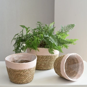 Detail of woven seagrass plant pots with pink cotton rope and waterproof liners