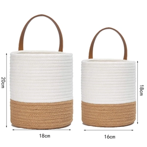 Detail of two-tone cotton woven hanging baskets with brown leather handles in two sizes