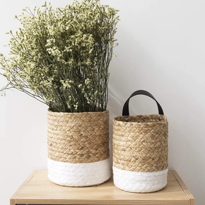 Detail of woven seagrass storage baskets with natural and white two-tone contrast design