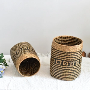 Detail of hand-woven storage basket with ethnic geometric pattern and round rim