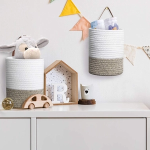 Two-tone cotton rope storage baskets with leather handles in a cozy nursery setting
