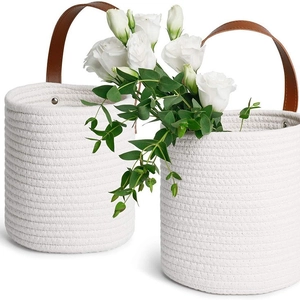 Set of two white cotton woven hanging baskets with brown leather handles for plants