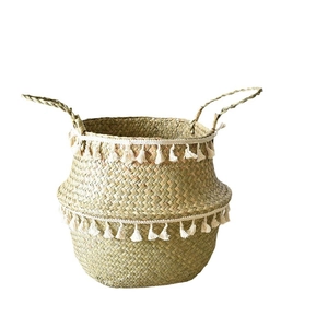 Foldable seagrass belly basket with cream tassels for home storage and plant decor