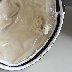 Detail of linen plant pot bag showing waterproof plastic lining and cotton rope handle