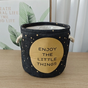 Close-up of linen storage basket with star pattern and Enjoy The Little Things print