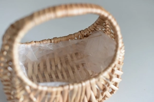 Detail of hand-woven wicker flower basket with a waterproof plastic liner and natural texture
